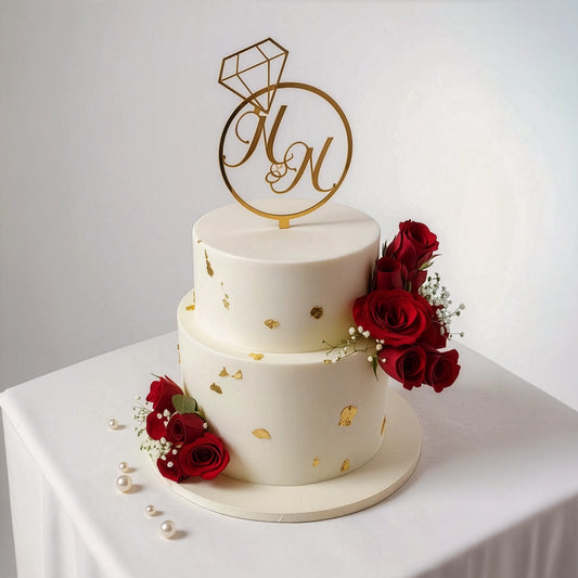 2-tier white elegant wedding cake with fresh red roses, delicate baby's breath, gold accents, and a monogram topper by PuffyClouds, Kochi