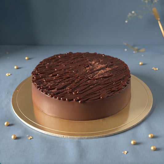 Belgian Chocolate Truffle Cake handcrafted with rich Belgian chocolate by PuffyClouds Cakes in Kakkanad, Kochi.
