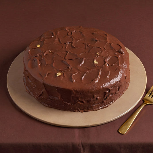 Rich Matilda chocolate cake with layers of moist chocolate sponge, fudge frosting and chocolate ganache handcrafted by PuffyClouds Cakes in Kochi.